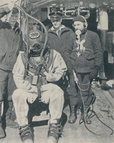 American Naval Diver wears three-fingered watertight rubber gloves 1937