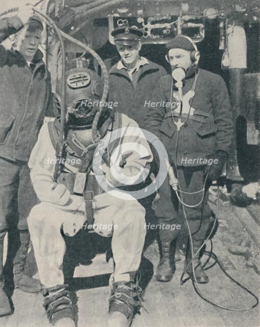 'American Naval Diver wears three-fingered watertight rubber gloves', 1937. Artist: Unknown.