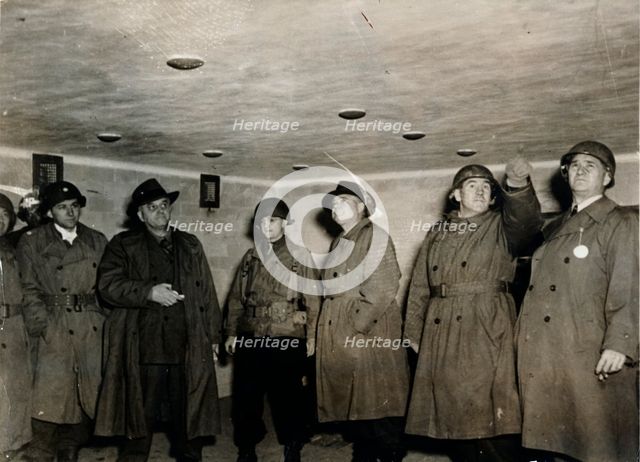 American soldiers examine a gas chamber, Dachau concentration camp, Bavaria, Germany, c1945. Creator: Unknown.