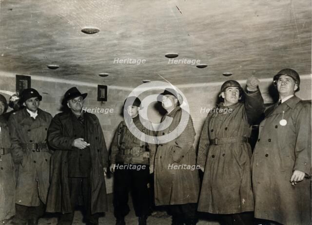 American soldiers examine a gas chamber, Dachau concentration camp, Bavaria, Germany, c1945. Artist: Unknown