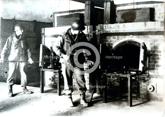 American soldiers studying a crematorium, Dachau concentration camp, Bavaria, Germany, c1945. Creator: Unknown.