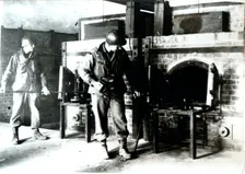 American soldiers studying a crematorium, Dachau concentration camp, Bavaria, Germany, c1945. Creator: Unknown