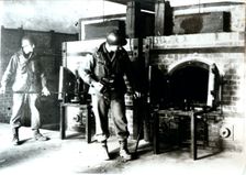 American soldiers studying a crematorium, Dachau concentration camp, Bavaria, Germany, c1945. Creator: Unknown