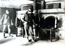 American soldiers studying a crematorium, Dachau concentration camp, Bavaria, Germany, c1945