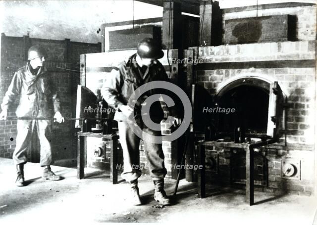American soldiers studying a crematorium, Dachau concentration camp, Bavaria, Germany, c1945. Artist: Unknown