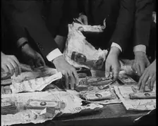 American Police Officers Counting Money Found in Relation To the Lindbergh's Kidnapping Case, 1930s. Creator: British Pathe Ltd