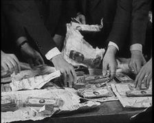 American Police Officers Counting Money Found in Relation To the Lindbergh's Kidnapping Case, 1930s. Creator: British Pathe Ltd