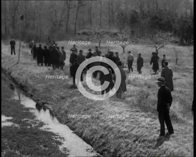 American Police Officers Searching the Area Outside American Aviator Charles Augustus..., 1930s. Creator: British Pathe Ltd.
