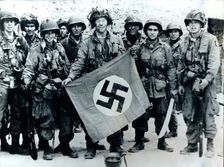 American parachute troops with a captured Nazi flag, Normandy, World War II, 6 June 1944. Creator: Unknown