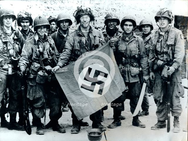 American parachute troops with a captured Nazi flag, Normandy, World War II, 6 June 1944. Creator: Unknown.