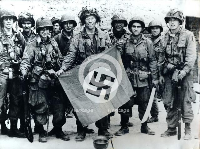American parachute troops with a captured Nazi flag, Normandy, World War II, 6 June 1944. Artist: Unknown