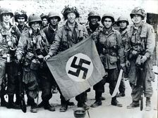 American parachute troops with a captured Nazi flag, Normandy, World War II, 6 June 1944