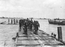 American troop debarkation, on a pontoon built by the Seabees Normandy, France, 1944