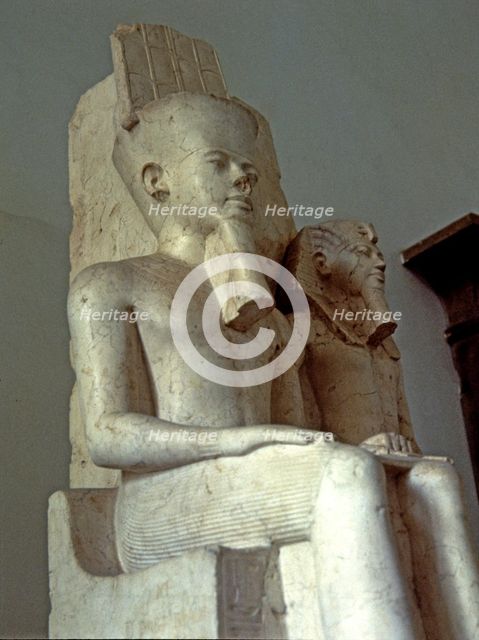 Amon seated next to Tutankhamun, statue made in calcite, 1350 BC.