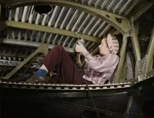 An A-20 bomber being riveted by a woman...Douglas Aircraft Company plant at Long Beach, Calif., 1942 Creator: Alfred T Palmer