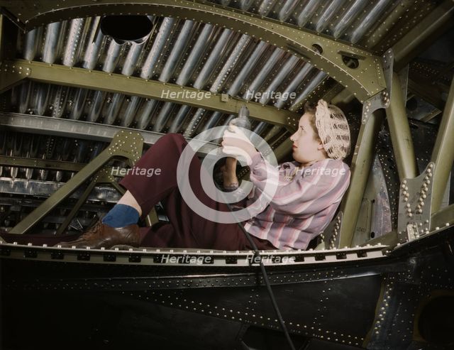 An A-20 bomber being riveted by a woman...Douglas Aircraft Company plant at Long Beach, Calif., 1942 Creator: Alfred T Palmer.