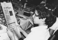 An American boy reading his Bar Mitzvah certificate, Israel, 1971. Creator: Unknown