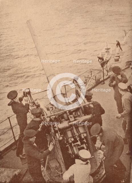 An anti-aircraft gun in action on a British battleship, c1917 (1919). Artist: Unknown.