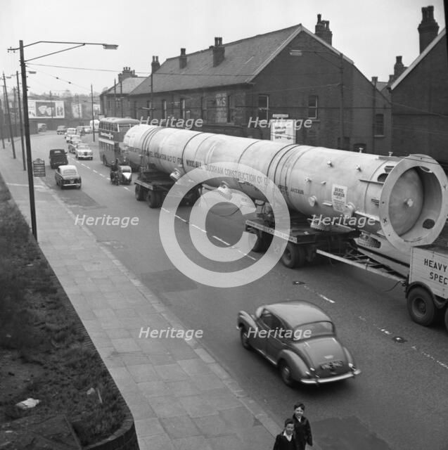An absorption tower being transported by road, Dukenfield, Manchester, 1962. Artist: Michael Walters