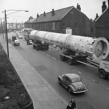 An absorption tower being transported by road, Dukenfield, Manchester, 1962. Artist: Michael Walters