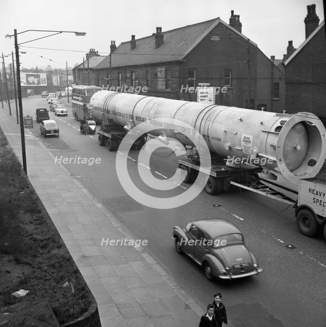 An absorption tower being transported by road, Dukenfield, Manchester, 1962. Creator: Michael Walters.