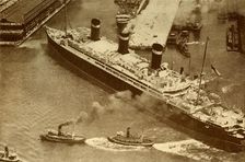 An Aerial Photograph of the "Leviathan" Being Towed By Small Tugs Into Her Dock At New York c1930 Creator: Unknown