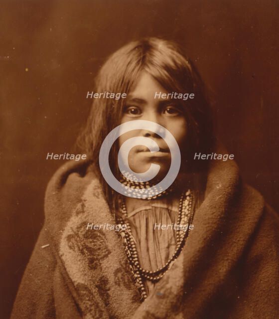 An Apache girl, head-and-shoulders portrait, facing front, wearing bead necklace..., c1903. Creator: Edward Sheriff Curtis.