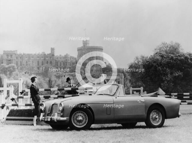 An Aston Martin DB2-4 MKII, with Windsor Castle in the background, 1956. Artist: Unknown
