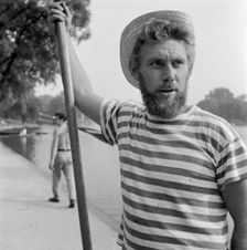 An boatman wearing a stripey T-shirt and a straw boater, Greater London, c1946-c1959. Artist: John Gay