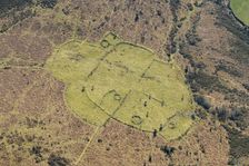 An enclosed stone hut circle settlement on Buckland Common, Dartmoor, Devon, 2025. Creator: Damian Grady