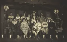 An ensemble cast of British soldiers, some in drag, pose on stage, 1919. Creator: Unknown