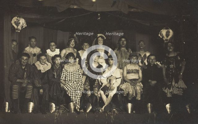 An ensemble cast of British soldiers, some in drag, pose on stage, 1919. Creator: Unknown.