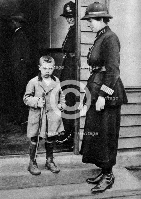 An East End child and a policewoman, London, 1926-1927. Artist: Unknown
