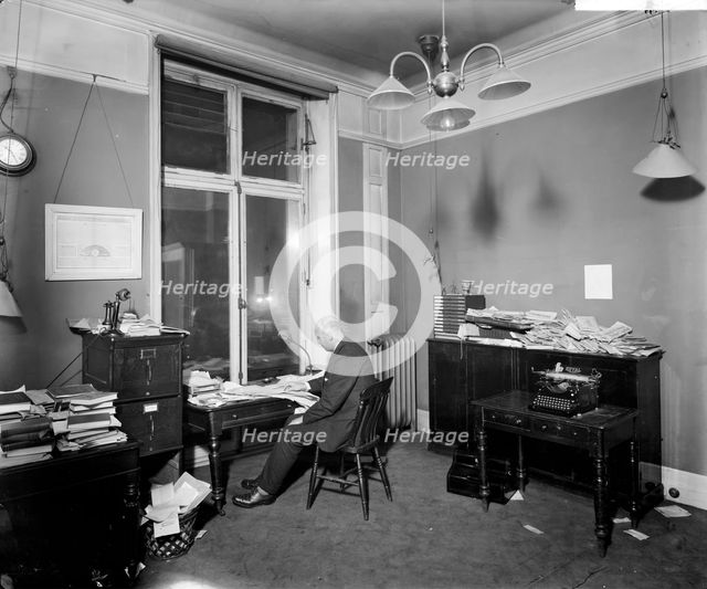 An editor working late in the Morning Post offices at Inveresk House, Westminster, London, 1920. Artist: Bedford Lemere and Company