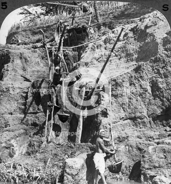 An Egyptian 'shaduf' lifting the Nile waters to the thirsty fields, Egypt', 1905.Artist: Underwood & Underwood