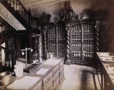 An eighteenth-century apothecary's shop with intricately carved wooden showcases; recreated.... Creator: Unknown