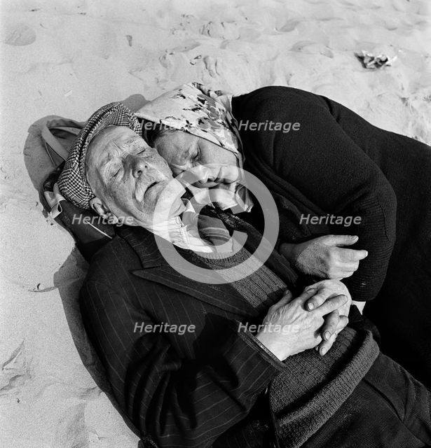 An elderly couple doze on the beach, Blackpool, c1946-c1955. Artist: John Gay