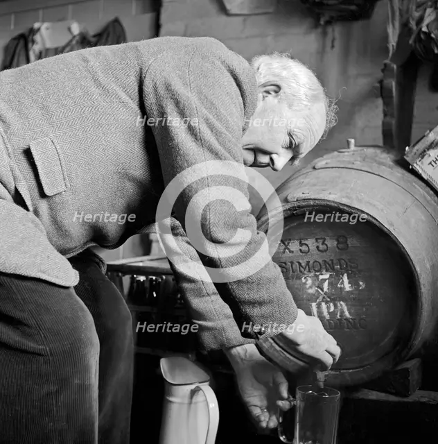 An elderly Gloucestershire man pouring a pint of beer, c1946-c1949. Artist: John Gay