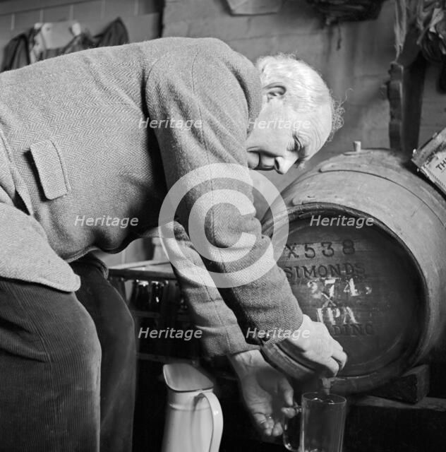 An elderly Gloucestershire man pouring a pint of beer, c1946-c1949. Artist: John Gay