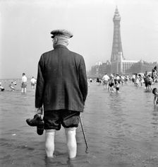 An elderly man paddling in the sea, Blackpool, c1946-c1955. Artist: John Gay