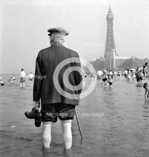 An elderly man paddling in the sea, Blackpool, c1946-c1955. Artist: John Gay