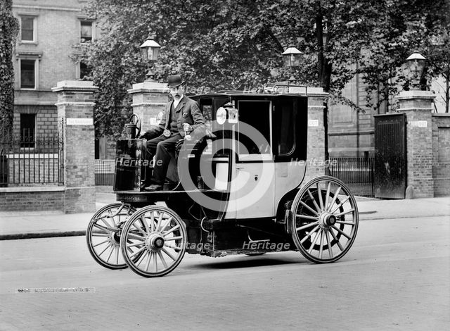 An electric motor cab and driver, London, c1897-c1900. Artist: York & Son.