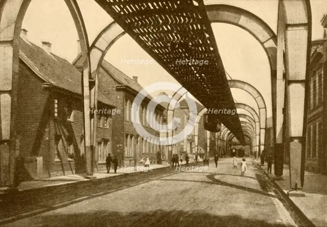 'An Electric Suspension Mono-Rail System', 1930. Creator: ENA.