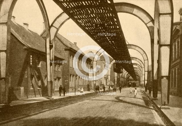 'An Electric Suspension Mono-Rail System', 1930. Creator: ENA.