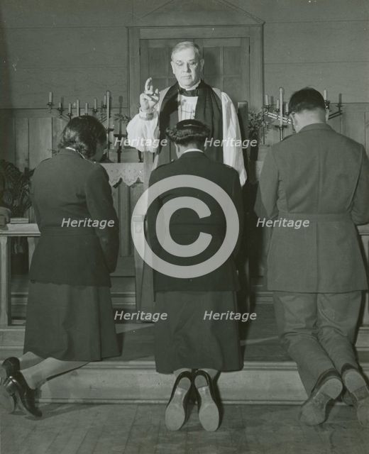 An Episcopal Bishop confirming African American Lieutenants Rosemary Vincent..., 1939 - 1945. Creator: United States Army.
