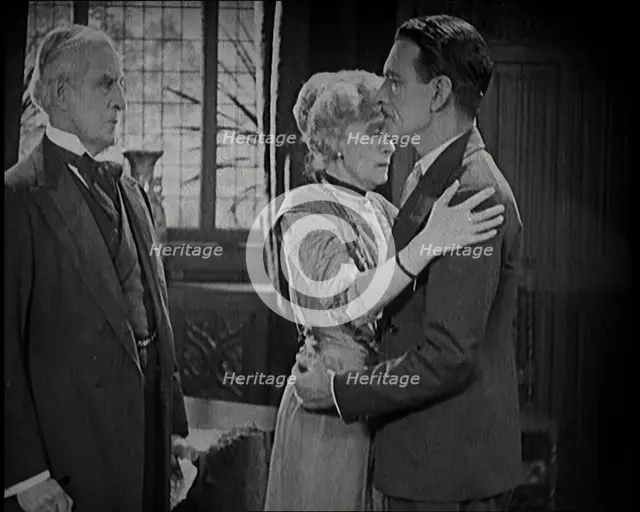An Extract from a Silent Film. A Female Actor and a Male Actor Embrace. Another Male Actor..., 1920s Creator: British Pathe Ltd.