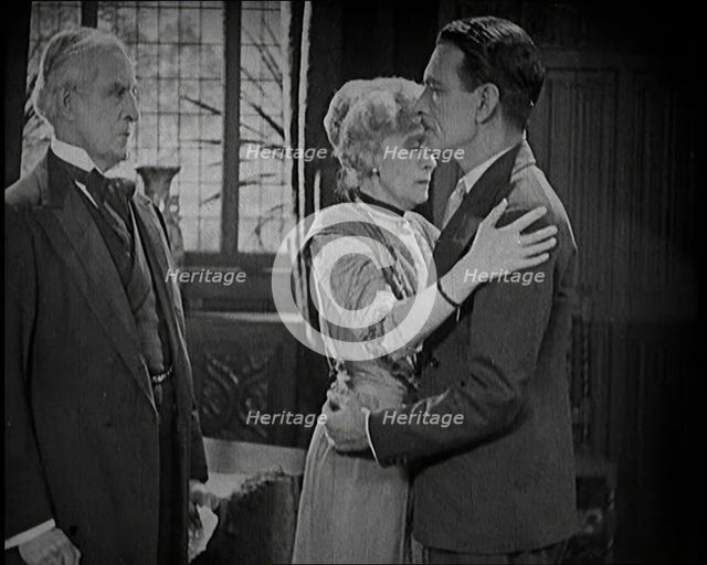 An Extract from a Silent Film. A Female Actor and a Male Actor Embrace. Another Male Actor..., 1920s Creator: British Pathe Ltd.