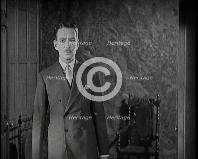 An Extract from a Silent Film. A Male Actor Enters Through a Door, 1920s. Creator: British Pathe Ltd.