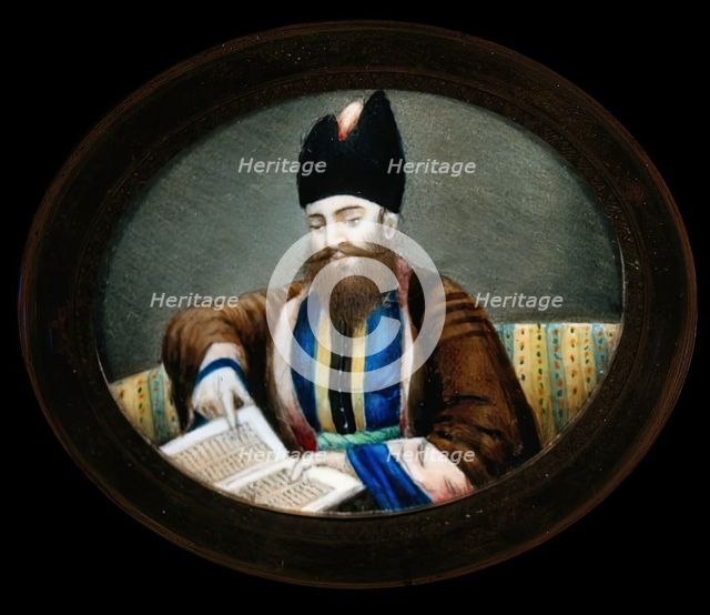 An Indian (?) man seated, reading a book. Creator: Unknown.