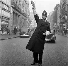 An informal portrait of a traffic policeman standing in the road, City of London, c1946-c1959. Artist: John Gay